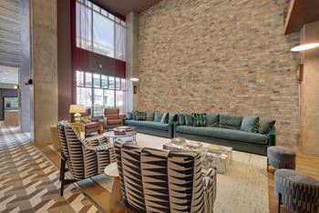 a living room with couches and chairs and a table at Link Apartments® Broad Ave, Memphis, Tennessee